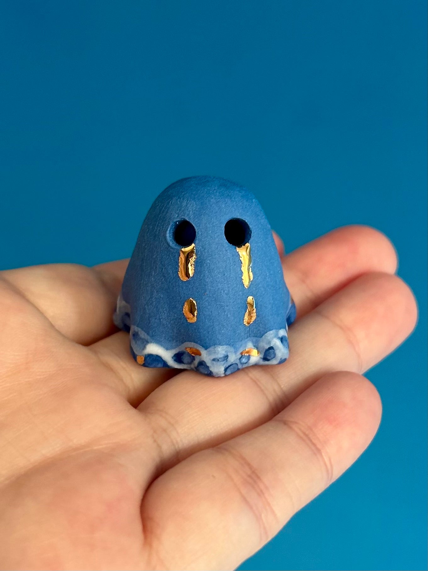 Blue Ghost with Gold Tears dripping into the Lake