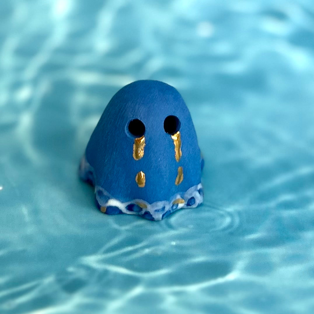Blue Ghost with Gold Tears dripping into the Lake