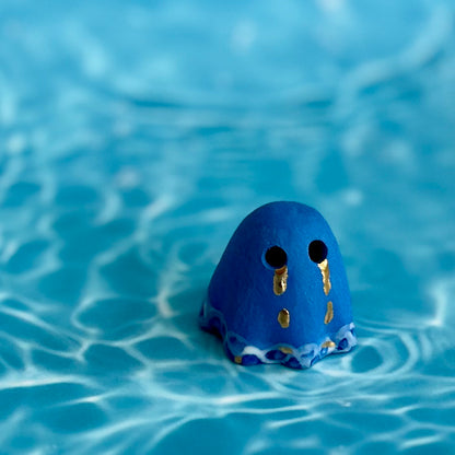 Blue Ghost with Gold Tears dripping into the Lake