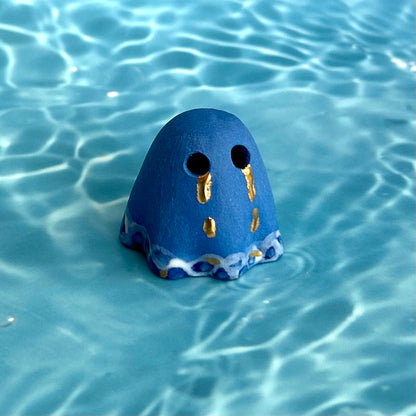 Blue Ghost with Gold Tears dripping into the Lake
